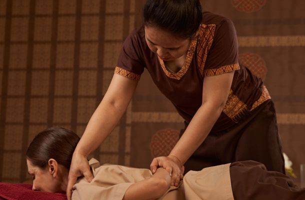 A massage therapist performing Houston Thai stretching