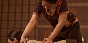 A massage therapist performing Houston Thai stretching